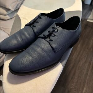 Tod’s blue leather oxfords.
